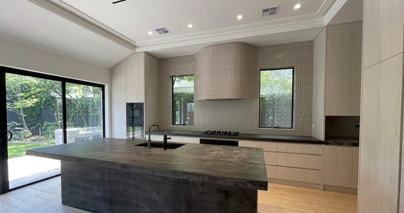 Staniland House — the new kitchen in grey-washed timber, sage tiles and aged brass